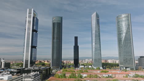 Soaring-over-Madrid's-financial-district-unveils-a-dance-of-steel,-glass