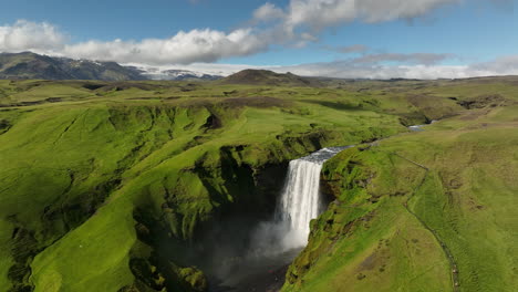 waterfall-in-the-mountains-of-Iceland-volcanic-glacier-in-background-aerial