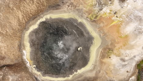 geothermal-field-boiling-water-in-a-natural-basin-aerial-top-shot-slow-motion