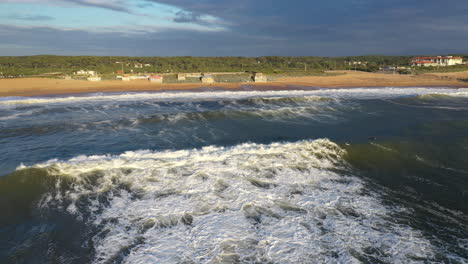Sunset-over-big-waves-crashing-on-a-beach-shore-Anglet-la-Barre-surf-spot