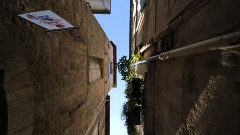 Beautiful-underneath-view-of-a-narrow-street-in-Montpellier-blue-sky-sunny-day