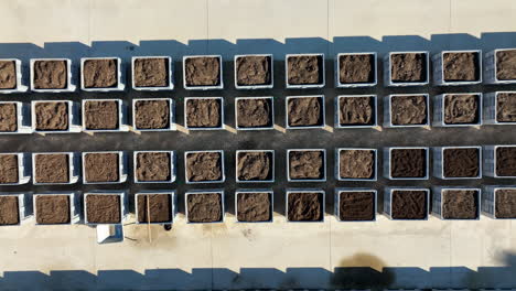 Overhead-shot-of-pots-filled-with-dirt-aerial-sunny-day-Montpellier