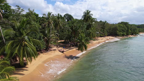 Aerial-drone-captures-Puerto-Viejo,-Costa-Rica's-coastal-charm-where-the-beach