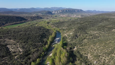 Cevennes-national-park-view-from-the-distance-over-a-river-along-trees-France