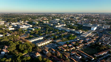 Birds-eye-view-of-Montpellier's-roads,-buildings,-and-lush-green-areas,