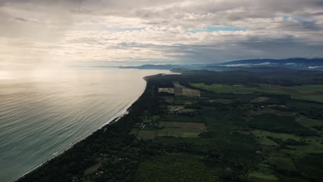 Costa-Rica's-coastal-expanse-meets-verdant-fields-under-a-cloudy-sky.