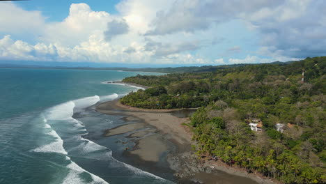 Costa-Rica's-coastal-landscape:-green-hills,-rocky-shores,-blue-waters.