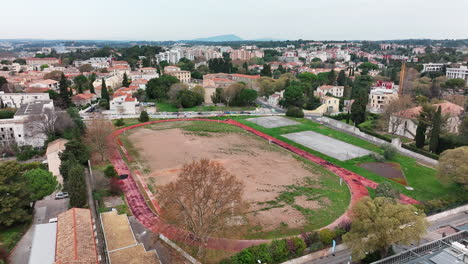 Overhead-shot-of-Montpellier's-deserted-sports-arena-with-a-neglected-track.