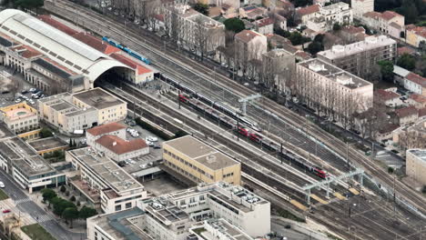 Soaring-above-Avignon's-train-hub,-capturing-its-intricate-layout-and-connectivi
