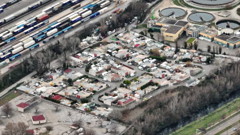 Aerial-of-Avignon's-water-treatment-site-juxtaposed-with-the-neighboring-gypsy-c
