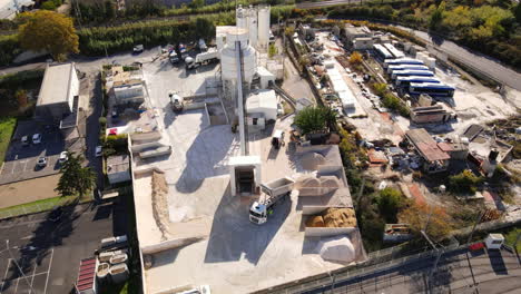Overhead-shot-of-a-bustling-Montpellier-construction-area-with-silos,-trucks