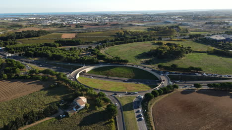 Drone-shot-of-a-bustling-roundabout,-illustrating-Montpellier's-dynamic-roadways