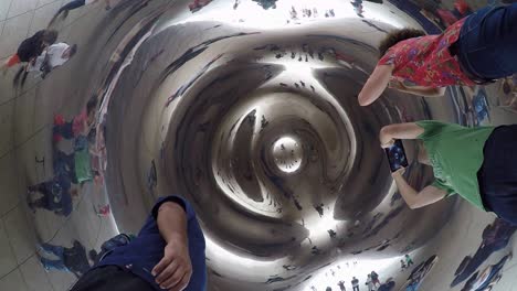 Inside-View-of-Cloud-Gate-Sculpture-in-Chicago-with-Tourist-Taking-Picture