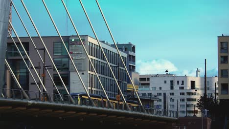 Street-tram-crosses-Crusell-cable-stayed-bridge-in-Helsinki,-Finland