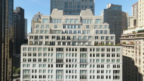 Aerial-view-away-from-the-15-Central-park-west-building,-in-sunny-NY---pull-back,-drone-shot