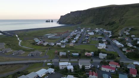Experience-the-serenity-of-Vik,-Iceland,-through-a-summer-drone-shot-at-sundown