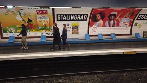 Closeup-Paris-Metro-Shot-of-Train-in-Motion-and-People-Walking-Inside-Station-Stalingard