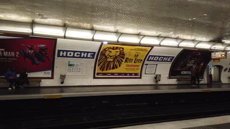 People-Walk-By-inside-Metro-Train-Underground-Hoche-Station-in-Paris