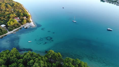 Yacht-and-ships-in-seaside-in-the-beautiful-blue-bay---long-aerial-shot
