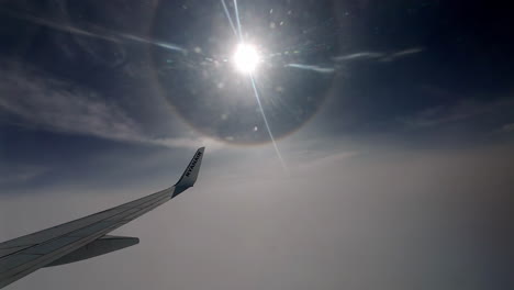 Ryanair-Aircraft-Wing-And-Winglet-In-High-Altitude-With-View-Of-Sun-And-Its-Halo