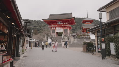 Young-Asian-girls-in-kimono-walking-towards-Niomon-Gate-at-Kiyomizudera-Temple-in-Kyoto-with-very-few-tourists-during-COVID-19-pandemic