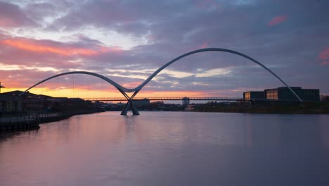A-timelapse-of-the-sunset-over-the-Infinity-Bridge,-Stockton-on-Tees