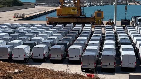 Numerous-white-stocked-vans-ready-to-be-loaded-at-Punta-Penna-port-dock-in-Italy-Automotive-industry