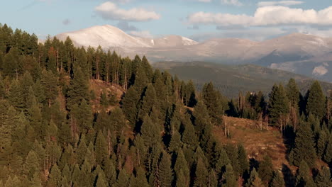 Cinematic-aerial-drone-zoomed-first-snow-on-Denver-Mount-Blue-Sky-Evans-14er-peak-early-autumn-fall-beautiful-golden-yellow-morning-sunrise-day-Colorado-Rocky-Mountains-circle-slowly-right-motion
