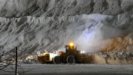 Snowblower-at-night-shift-Blowing-the-Snow-in-to-a-Mountin