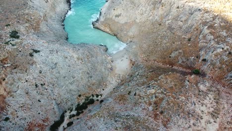 Majestic-beach-of-mountains-of-Seitan-Limania-in-Crete,-aerial-orbit-view
