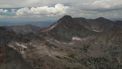 Cinematic-top-of-Rocky-Mountain-National-Park-Colorado-Denver-Boulder-Estes-Park-14er-Longs-Peak-looking-out-to-Indian-Peaks-cloudy-late-summer-dramatic-landscape-still