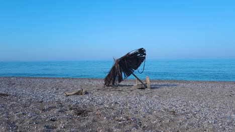Beautiful-Memories-of-a-Summer-Vacation:-Abandoned-Umbrellas-Evoke-Recollections-on-an-Empty-Beach-in-Mediterranean