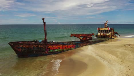 Famous-Colorful-Ship-Wrecked-Vessel-On-Manzanillo-Beach-Costa-Rica,-4K-Drone-Fly-Around