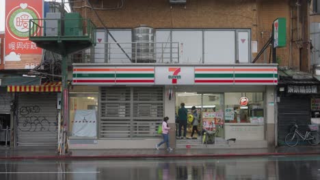 Muslim-Asian-Indonesian-Woman-in-Hijab-Walking-to-Convenience-Store-During-Rain