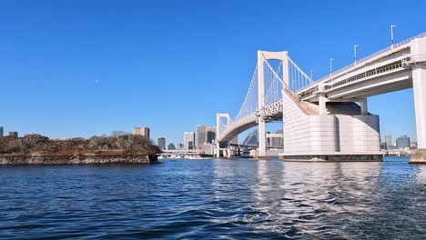 View-from-the-waters-at-odaiba,-Tokyo-on-the-Rainbow-bridge-in-Japan