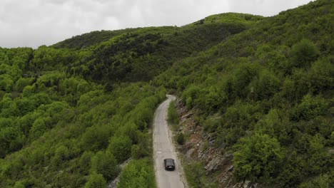 Aerial-shot-of-cars-moving-on-mountain-road-in-Stara-Planina,-Bulgaria
