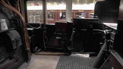 panning-shot-of-a-steam-locomotive-cab-in-The-National-Railway-Museum-In-York