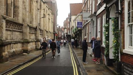 Hand-held-shot-of-tourists-walking-through-the-antique-streets-in-York