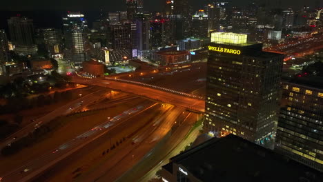 Aerial-time-lapse-shot-of-busy-multilane-highway-leading-through-night-metropolis