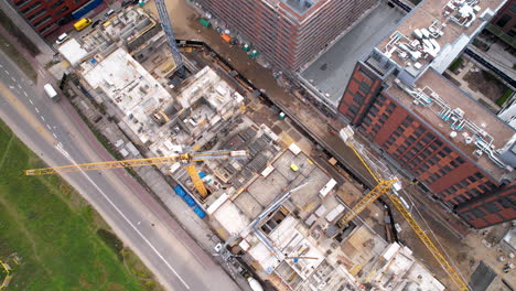 Aerial-satellite-view-above-construction-site-with-large-cranes-as-buildings-rise-in-Poland