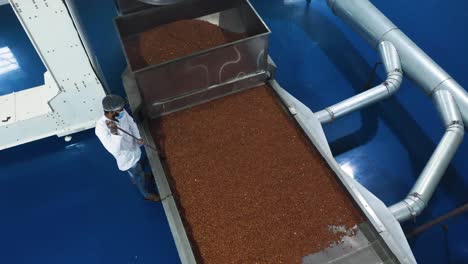 Peanut-butter-manufacturing-process,-aerial-top-view-showing-peanut-kernels-being-cooled