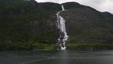 Langfoss-waterfall-dropping-down-steep-mountainside-with-great-power