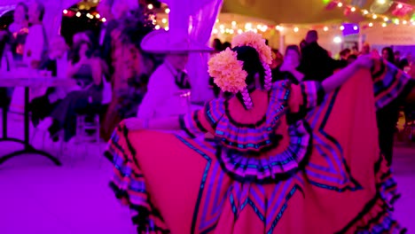 Latin-couple-wearing-traditional-Spanish-clothing-is-dancing-for-the-crowd-at-a-local-event-in-Chicago-to-provide-entertainment-the-woman-wears-a-red-dress-while-the-male-wear-a-sombrero-and-suit