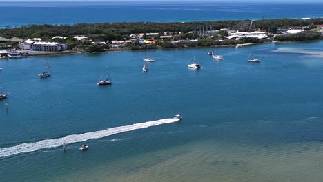 The-beautiful-Gold-Coast-Broadwater,-speeding-powerboat,-Luxury-High-rise-apartments,-summers-day,-done-footage