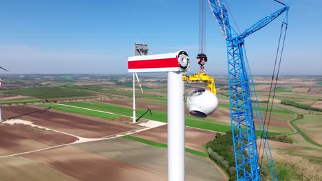 Construction-Of-A-Wind-Turbine-In-A-Wind-Farm-During-Daytime---aerial-shot