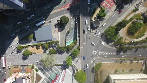 Cars-driving-along-complicated-intersection-in-Brisbane-Australia,-drone-top-down