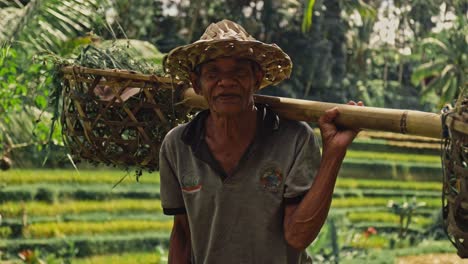 A-close-up-of-an-elderly,-happy-rice-farmer-in-a-straw-hat-in-Bali