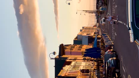 Urban-Safety:-Children-Crossing-Main-Street-in-Bantry,-Ireland,-Amidst-a-Beautiful-Sunset---Vertical-Video