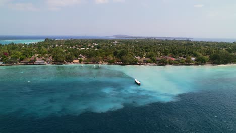 Tour-Boats-Anchored-in-Turquoise-Water-on-Coastline-of-Gili-Trawangan-Island---Aerial-Descending