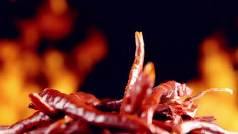Dried-red-hot-chili-peppers-with-a-fire-in-the-background